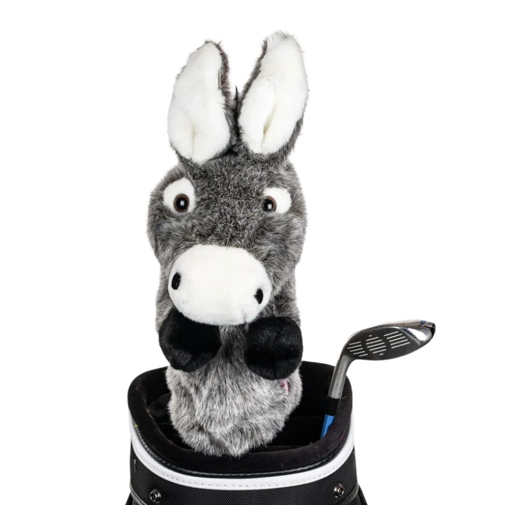 A donkey-shaped golf club head cover sitting in a golf bag, with a club peeking out.
