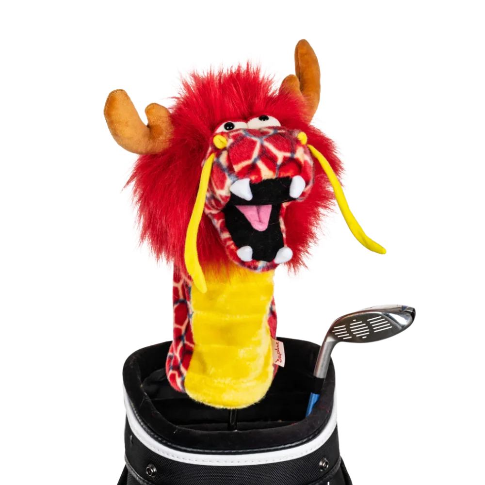 A dragon-shaped golf club head cover sitting in a golf bag, with a club peeking out.