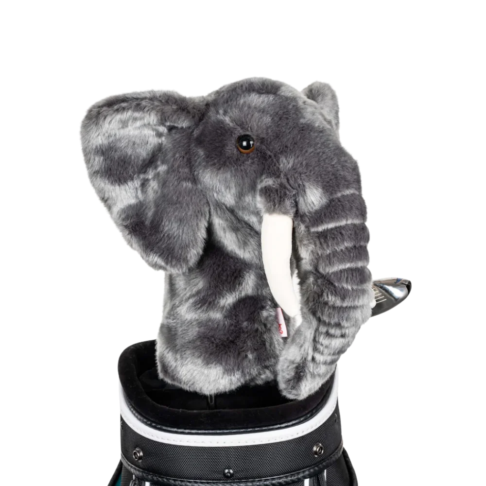 An elephant-shaped golf club head cover sitting in a golf bag, with a club peeking out.
