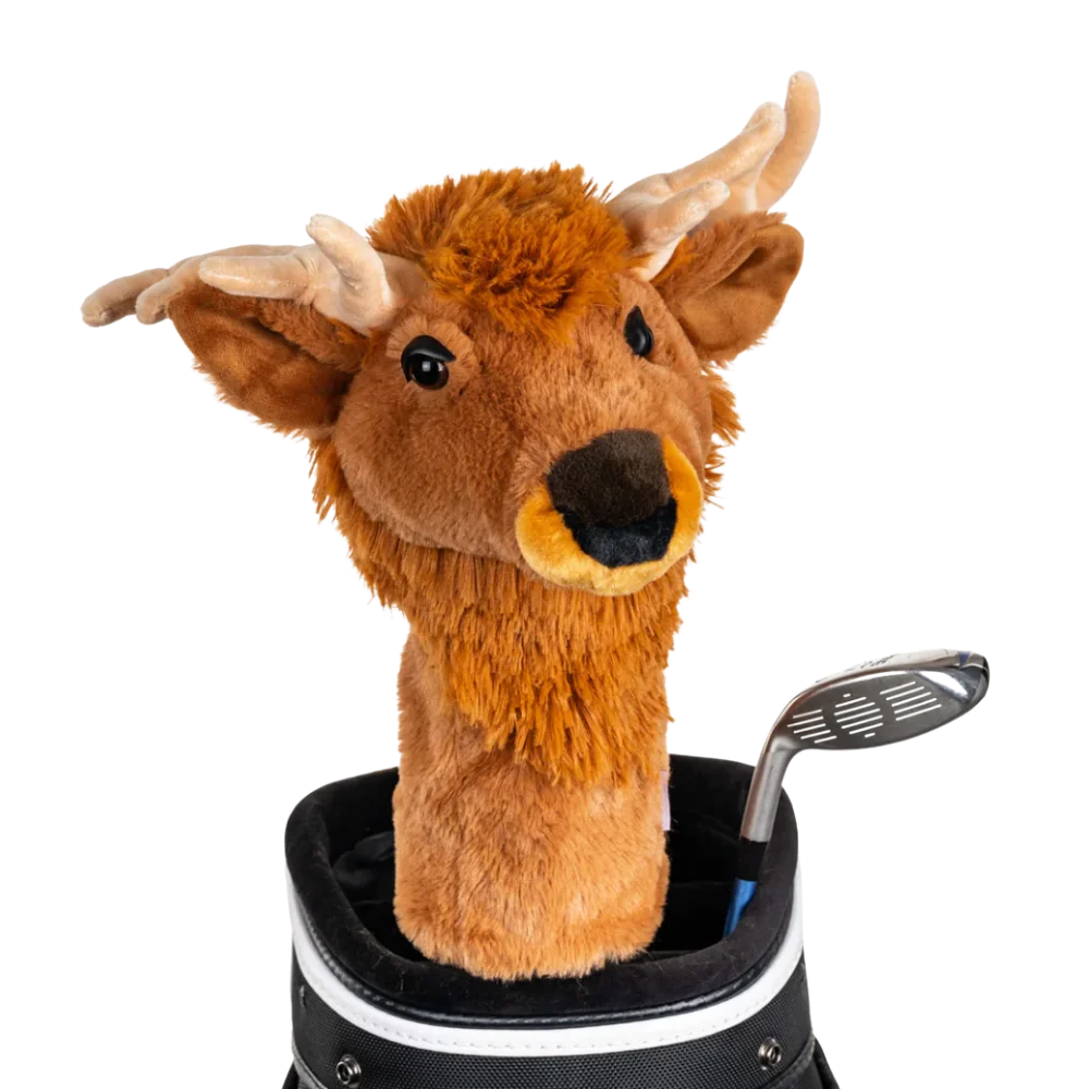 An elk-shaped golf club head cover sitting in a golf bag, with a club peeking out.