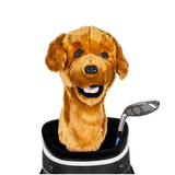 A plush dog golf cover peeks out from a golf bag pocket, beside a golf club.