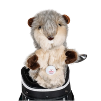 A gopher-shaped golf club head cover sitting in a golf bag, with a club peeking out.