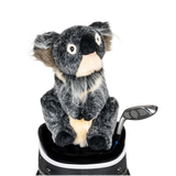 A koala-shaped golf club head cover sitting in a golf bag, with a club peeking out.
