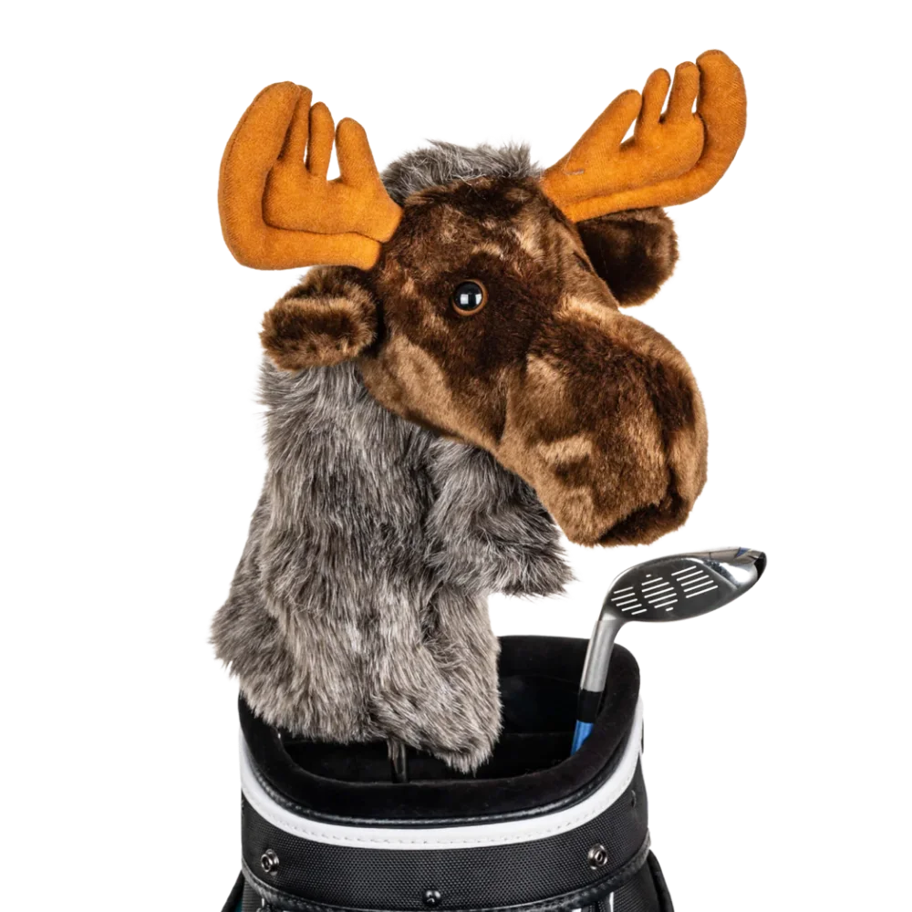 A moose-shaped golf club head cover sitting in a golf bag, with a club peeking out.