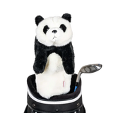 A panda-shaped golf club head cover sitting in a golf bag, with a club peeking out.