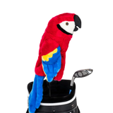 A parrot-shaped golf club head cover sitting in a golf bag, with a club peeking out.