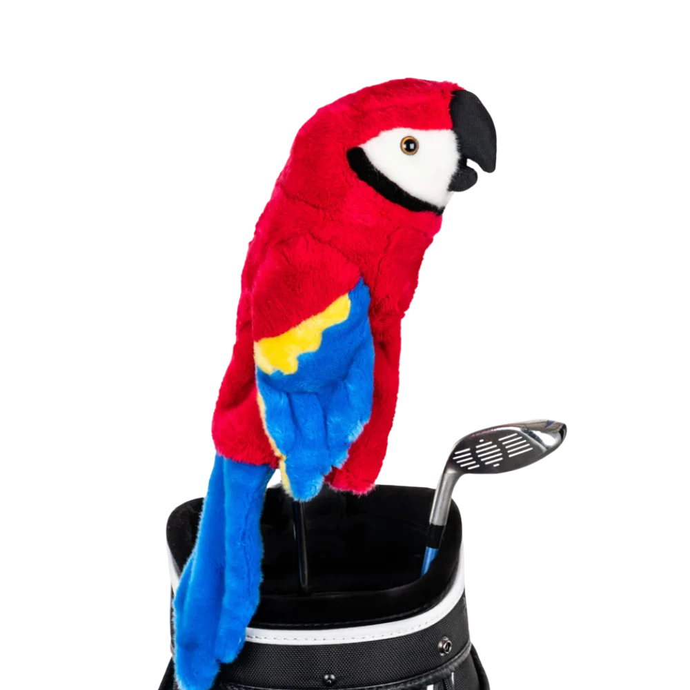A parrot-shaped golf club head cover sitting in a golf bag, with a club peeking out.
