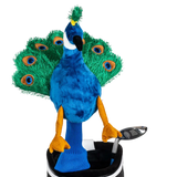 A peacock-shaped golf club head cover sitting in a golf bag, with a club peeking out.