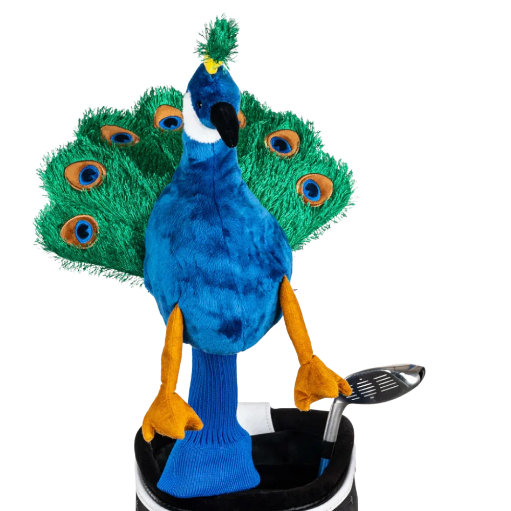 A peacock-shaped golf club head cover sitting in a golf bag, with a club peeking out.