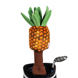 A pineapple-shaped golf club head cover sitting in a golf bag, with a club peeking out.