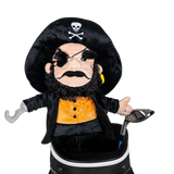 A pirate-shaped golf club head cover sitting in a golf bag, with a club peeking out.