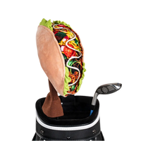 A taco-shaped golf club head cover sitting in a golf bag, with a club peeking out.