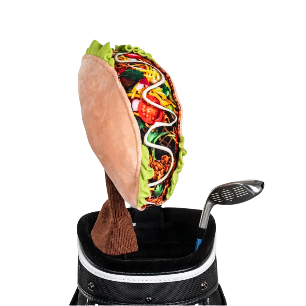 A taco-shaped golf club head cover sitting in a golf bag, with a club peeking out.