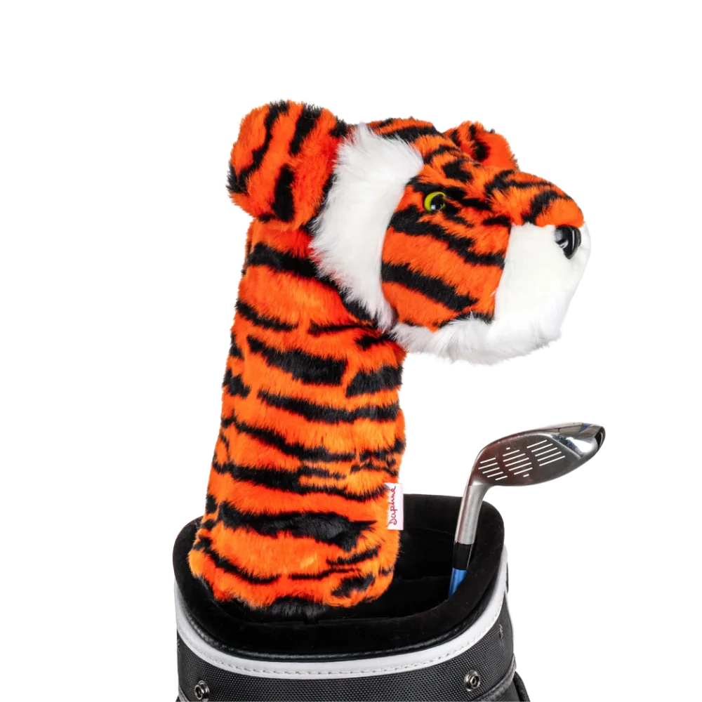 A tiger-shaped golf club head cover sitting in a golf bag, with a club peeking out.