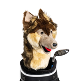 A wolf-shaped golf club head cover sitting in a golf bag, with a club peeking out.