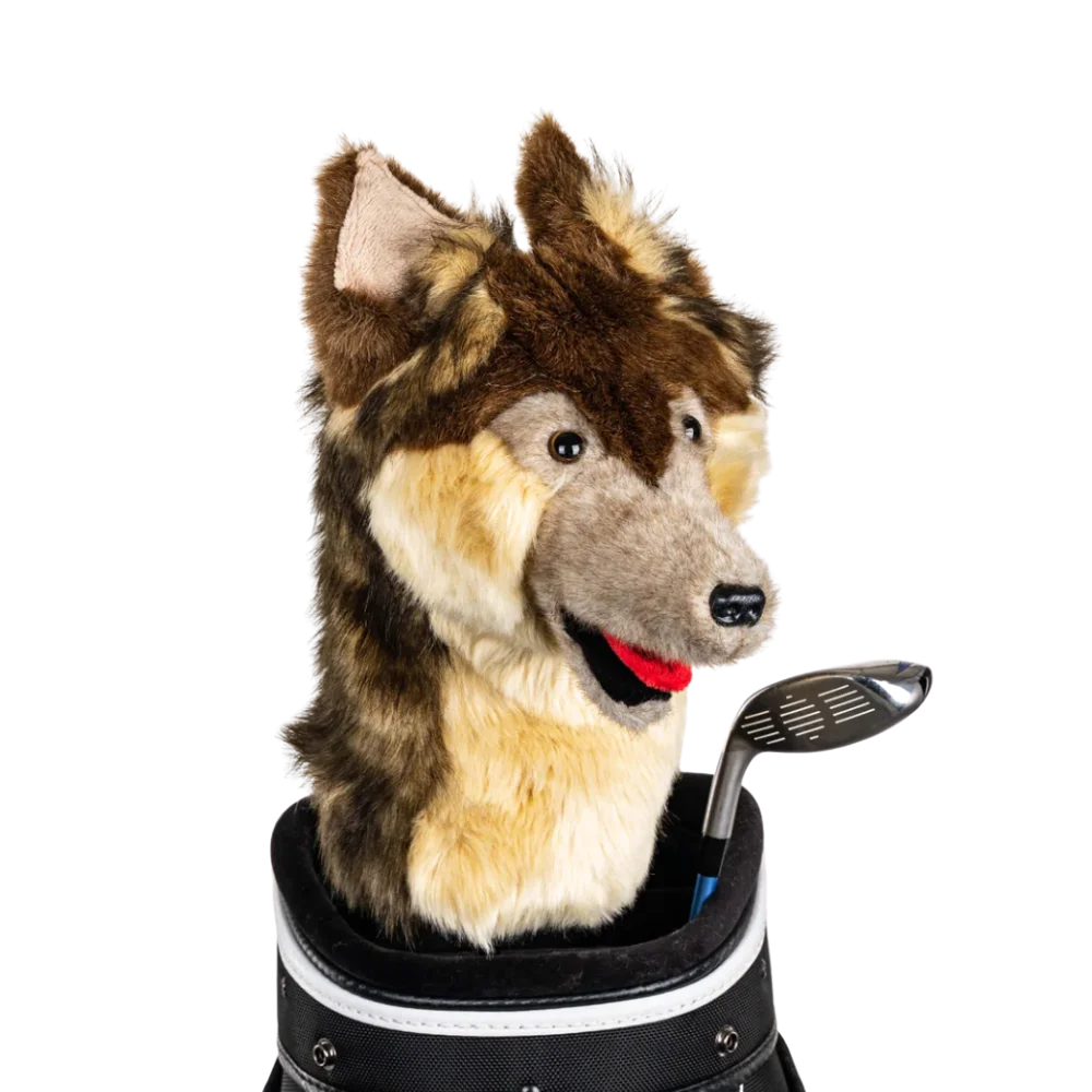 A wolf-shaped golf club head cover sitting in a golf bag, with a club peeking out.