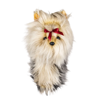 Plush golf head cover resembling a Yorkshire Terrier with a light-colored coat and a red ribbon in its hair.