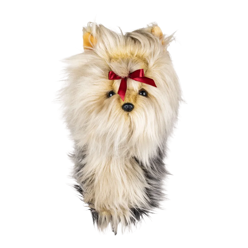 Plush golf head cover resembling a Yorkshire Terrier with a light-colored coat and a red ribbon in its hair.