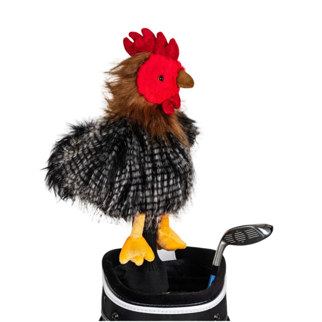 A chicken-shaped golf club head cover sitting in a golf bag, with a club peeking out.
