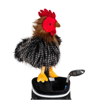 A chicken-shaped golf club head cover sitting in a golf bag, with a club peeking out.