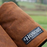 Close-up of the Honors Collection brown canvas barrel driver headcover and its leather logo patch.