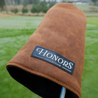 Close-up of the Honors Collection brown canvas barrel fairway headcover and its leather logo patch.