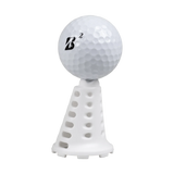 Golf ball resting on a white Pride Sports simulator tee.