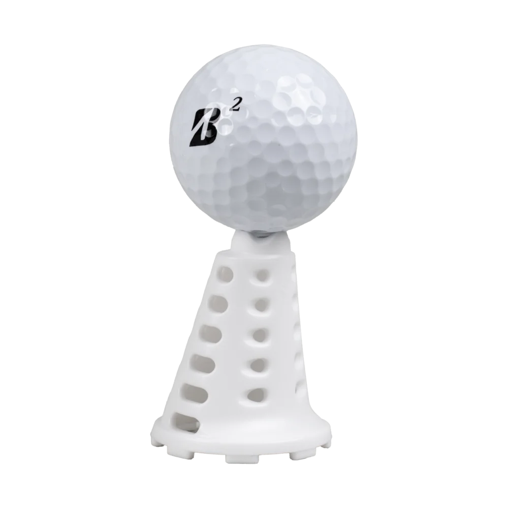 Golf ball resting on a white Pride Sports simulator tee.