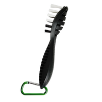 Black utility brush with white bristles and a green carabiner clip on a white background