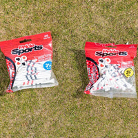 Two packages of pride sports golf tees on grass featuring special edition playing cards design, one containing 45 pieces of 3½ inch tees and the other containing 45 pieces of 2¾ inch tees.