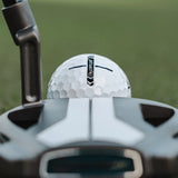 Golf club and golf ball with 'Distance' label on a blurred green background
