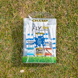 A package of white golf tees with blue stripes lying on grass, labeled "champ fly tee," containing 30 tees of 3¼ inches.